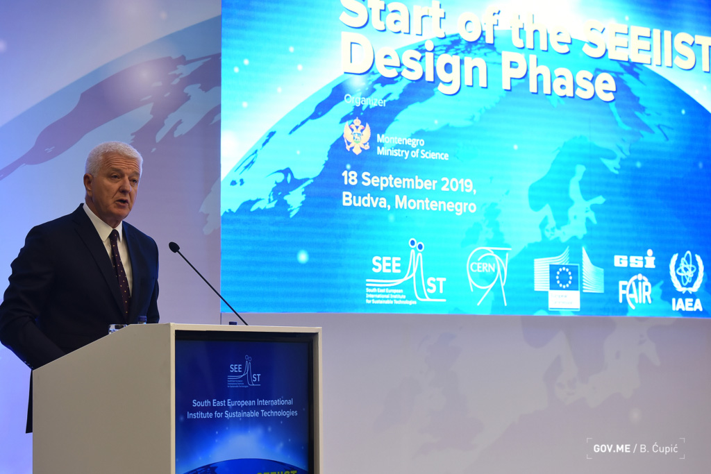 Montenegro prime minister Duško Marković giving a presentation in front of a blue screen on which is written "Start of the SEEIIST design phase - 18 September 2019" 