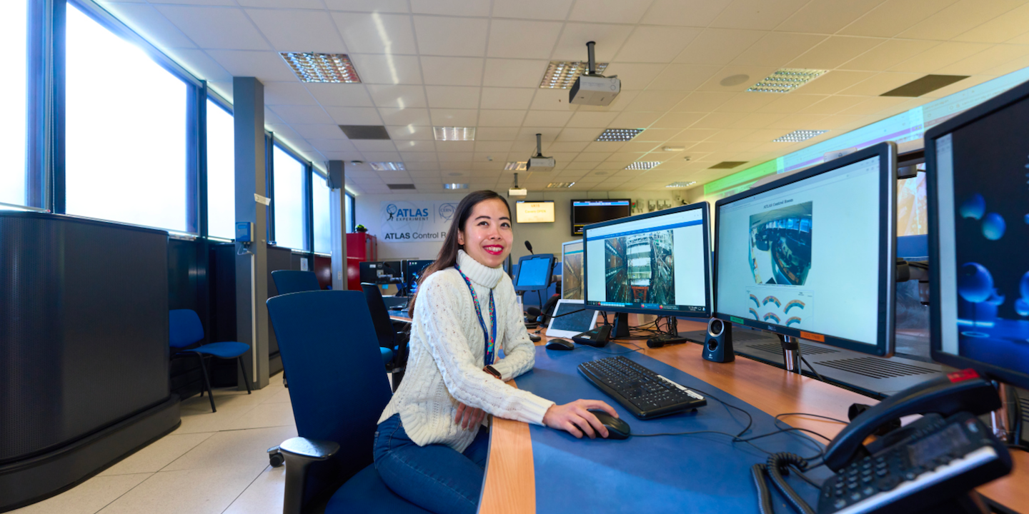 Joni, is eating in front of a computer inside the ATLAS control room