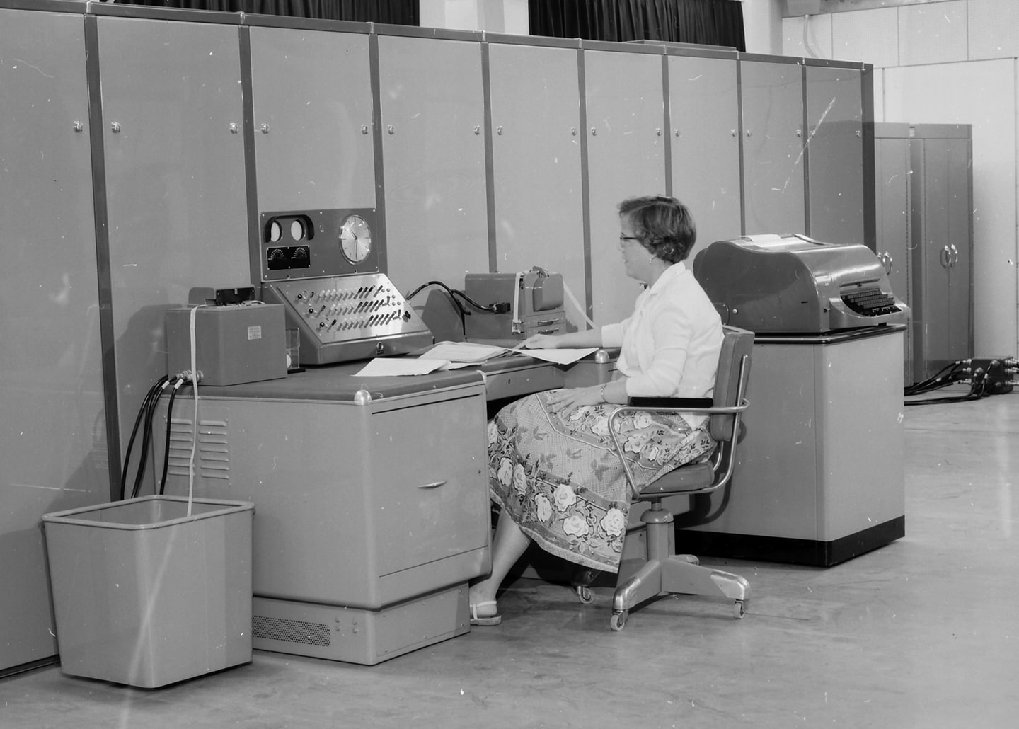 Women sitting in front of an old computer
