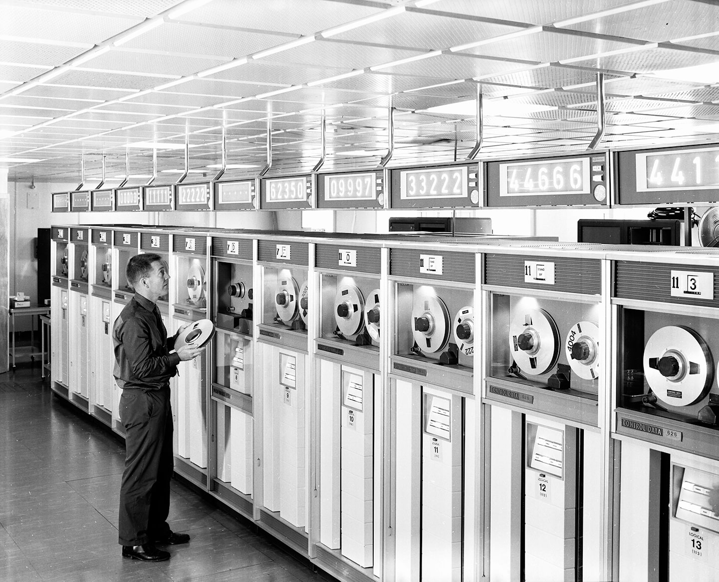 Man standing next to CDC 6600 computer tape units