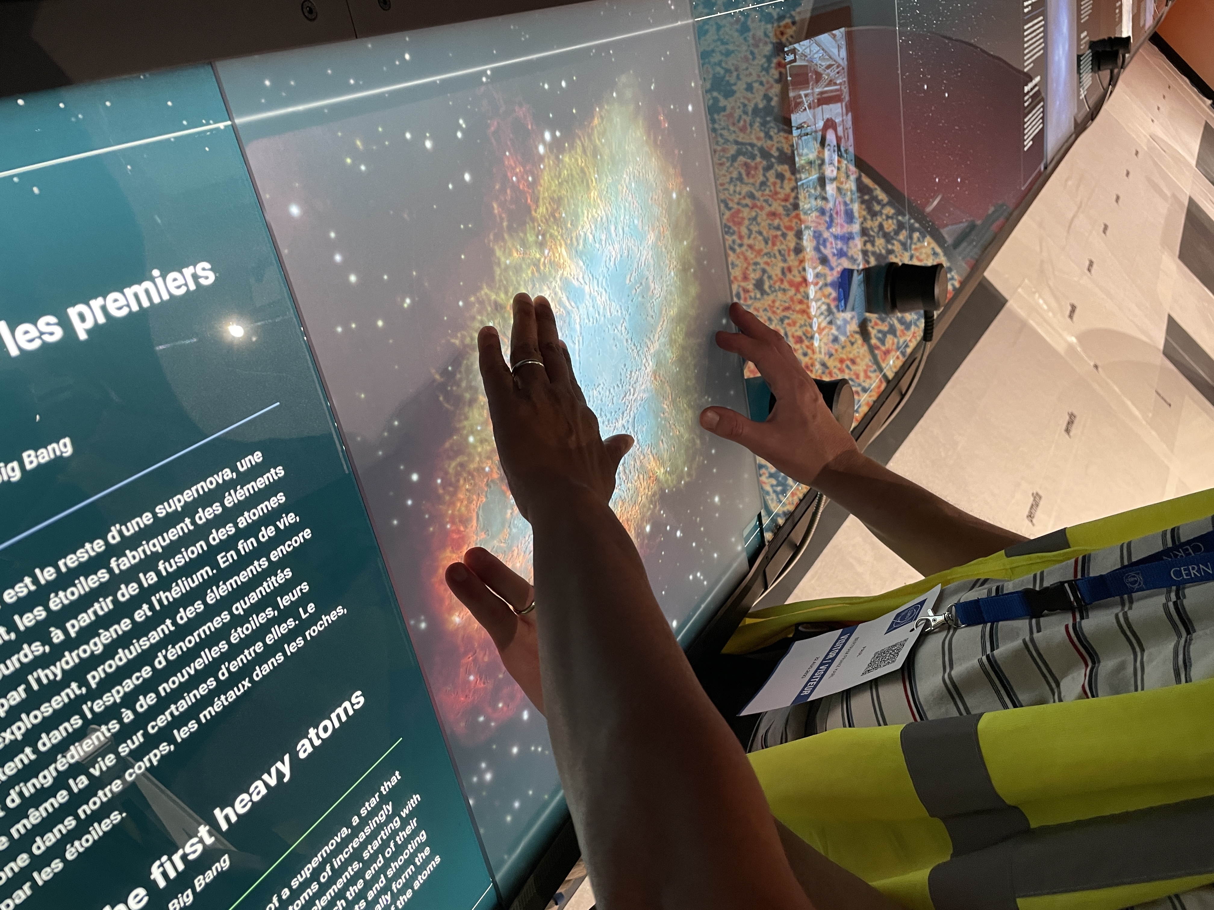 hands touching a picture of a nebula in relief